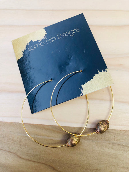 Gold bead accents on hoop earrings